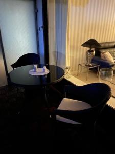 a room with a table and two chairs and a lamp at Top - Apartment mit Aussicht in Timmendorfer Strand