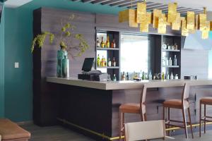 a bar in a restaurant with stools at Metria Hotel in León