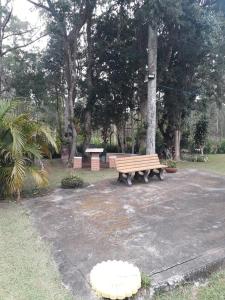 a park bench sitting in the middle of a park at Sítio Toa Toa in São Roque