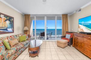a living room with a couch and a view of the ocean at San Carlos Unit 607 in Gulf Shores