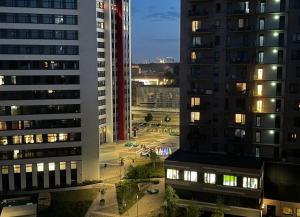 a view of a city at night with tall buildings at Jaunā Teika Penthouse in Rīga