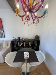 a living room with a table and a chandelier at Sagasta Centro in Logroño +18 photos