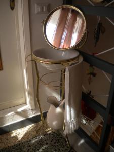 a mirror sitting on top of a stool in a room at casetta del nonno bis in Arcola