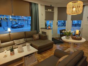 ein Wohnzimmer mit Sofa und Tisch in der Unterkunft Hotel Sfinx in De Panne