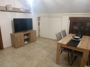 a dining room with a table and a television at alojamiento matilla in Baeza