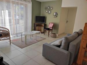 a living room with a couch and a table at La maison des chevreuils in Plouigneau