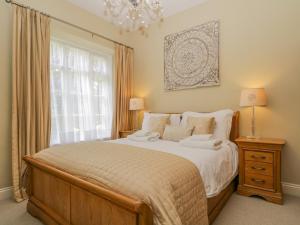 a bedroom with a large bed and a window at Garden Cottage in Keswick
