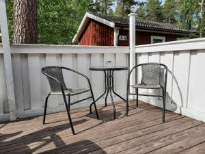 two chairs and a table on a deck at Dalastugan in Mora