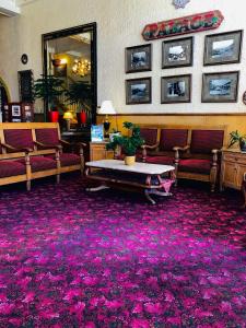 a waiting room with a purple carpet at The Palace Hotel in Silver City