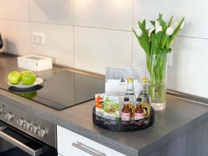 a tray with bottles of alcohol on a kitchen counter at WEINQUARTIER Naumburg 6 Apartments Eventraum Fahrradraum Kaffee Küche Parken in Naumburg +69 photos