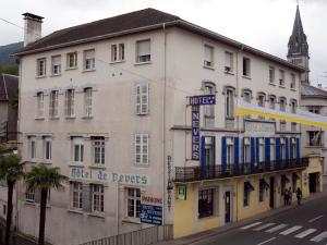 a white building with a sign on the side of it at Hôtel de Nevers in Lourdes