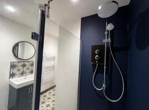 a bathroom with a shower with a mirror and a sink at Orchard Lodge -Coastal Retreat, new build, village views, private garden and terrace in Saint Brides Major +37 photos