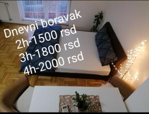 a living room with a couch and a table at Apartman Jaca in Požarevac