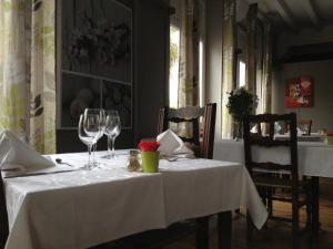 a table with wine glasses and napkins on it at Hôtel de Nevers in Lourdes