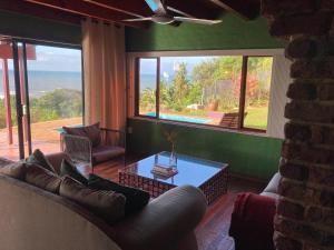 a living room with a couch and a table at Trafalgar Beach House in Trafalgar