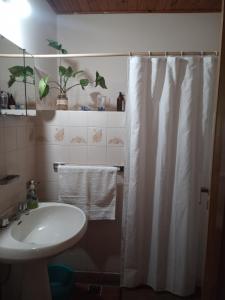 a bathroom with a sink and a shower curtain at Casa Raco in Raco