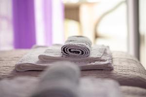 a rolled up towel sitting on top of a couch at mansion luxury apartment in Psakoudia +9 photos