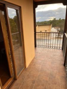 a balcony with sliding doors and a view of a building at Hostal Ciudad Encantada in Cuenca