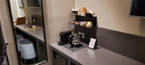 a room with a coffee maker on a counter at Santarella Guest House in Milan