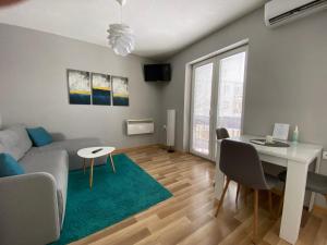 a living room with a couch and a table at Apartment 13 in Vrnjačka Banja