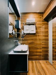 a bathroom with a sink and a mirror at Imperator Hotel in Tirana