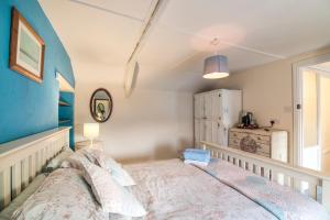 A bed or beds in a room at Manorbier Castle Inn Bay Room