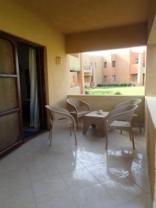 a room with chairs and a table and a window at Stella Makadi Palace Chalet in Hurghada