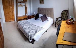 Postel nebo postele na pokoji v ubytování Hotel Gran Boutique Sabana