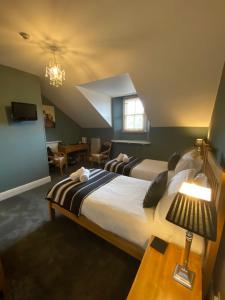 a bedroom with two beds and a living room at Ambleside Central in Ambleside