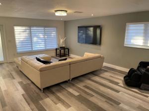 a living room with a couch and a television at Cozy MIA Airport Pool Home in Miami