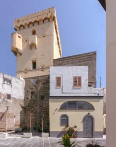a building in front of a castle at La casa del postino in Procida