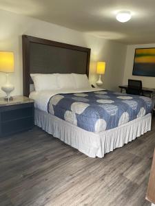 a bedroom with a large bed with two lamps at Extended Stay Studios in Montgomery
