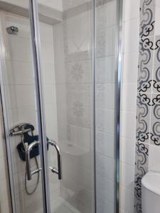 a shower with a glass door in a bathroom at Casa da Andorinha in Pardieiros