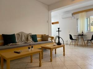 a living room with a couch and tables in it at Yiayia's House, in Zipari Village "1" in Zipárion