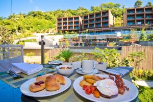 a table with two plates of food on it at Sunsuri Phuket - SHA Plus in Nai Harn Beach