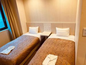 Cama ou camas em um quarto em Hotel Relief SAPPORO SUSUKINO - Vacation STAY 22963v