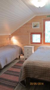 Postel nebo postele na pokoji v ubytování Lomakulkuri Apartments