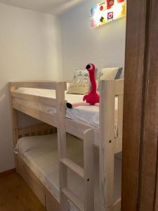 a wooden bunk bed with a toy dinosaur on top of it at Apartament Neptuno Platja d'Aro in Platja  d'Aro