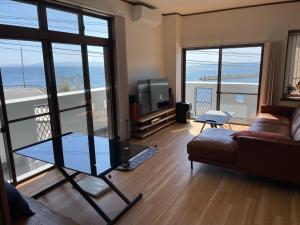 a living room with a couch and a glass table at Coast house Nabura - Vacation STAY 29534v in Nagasaki