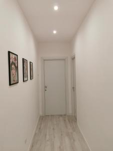 um quarto vazio com paredes brancas e pisos de madeira em Dimora Nalu em Bari