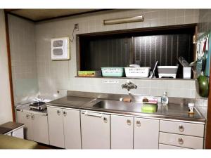 a kitchen with a sink and a counter top at Guest House Kushimoto - Vacation STAY 31002v in Kashino