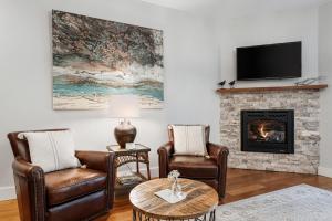 a living room with two chairs and a fireplace at Mossbrae Hotel in Dunsmuir