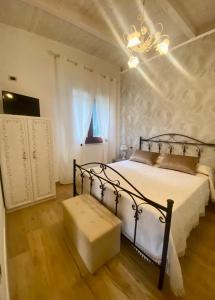 a bedroom with a bed and a chandelier at Chalet del girasole in Castellabate
