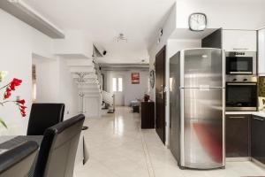 a kitchen with a stainless steel refrigerator in a room at Casa Corfiota in Corfu Town +7 photos