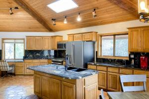 a kitchen with wooden cabinets and a stainless steel refrigerator at Sedona Serenity in Sedona