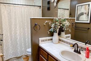 a bathroom with a sink and a vase of flowers at Sedona Serenity in Sedona +27 photos