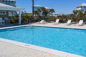 a swimming pool in a resort with chairs at Once Upon a Dream in Port Saint Joe