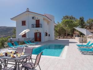 a villa with a swimming pool and a house at Villa Aura Pine in Agia Pelagia