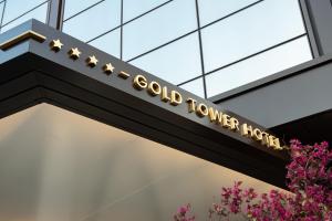 a sign for a gold tower hotel on a building at Gold Tower Lifestyle Hotel in Naples
