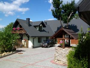 a house with a car parked in front of it at Stara Kuźnia in Sosnówka +75 photos